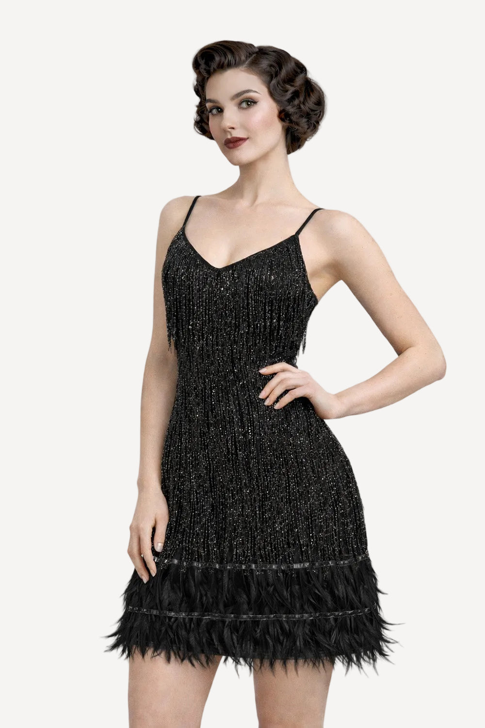 Woman wearing a 1920s style black dress with feather details on a white background
