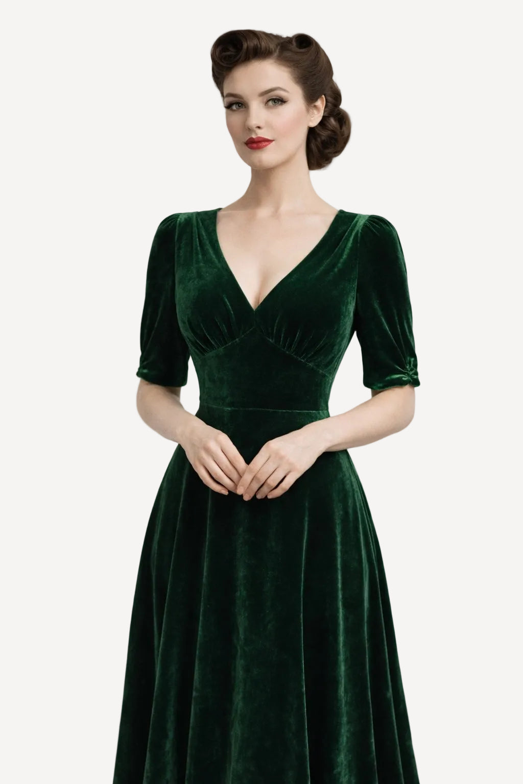 Woman wearing a green velvet dress against a plain background