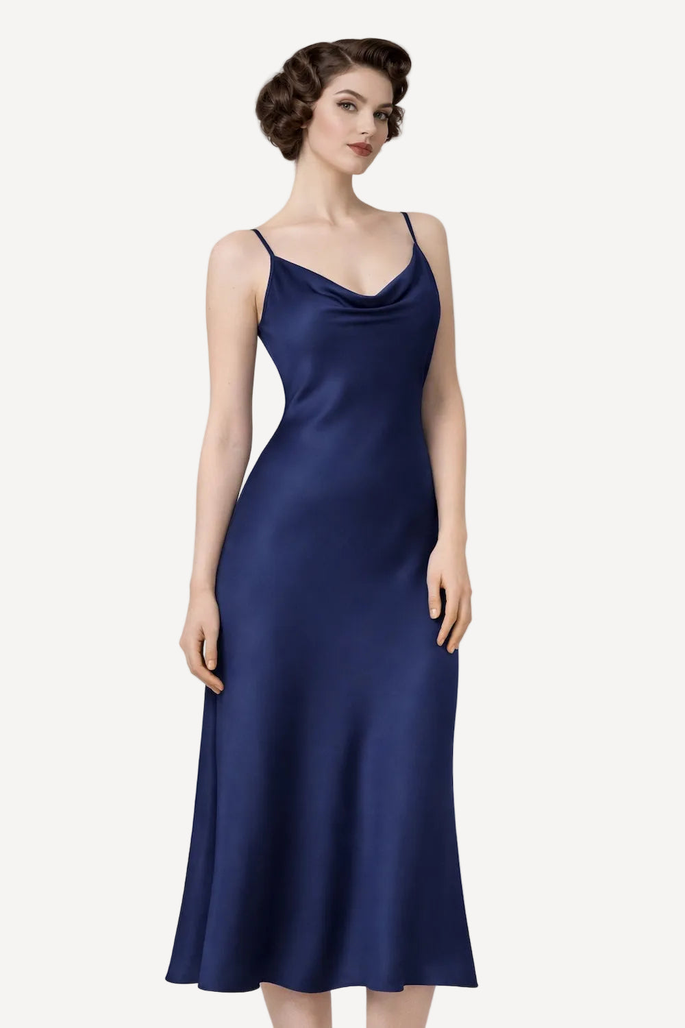 Woman wearing a navy blue slip dress on a white background