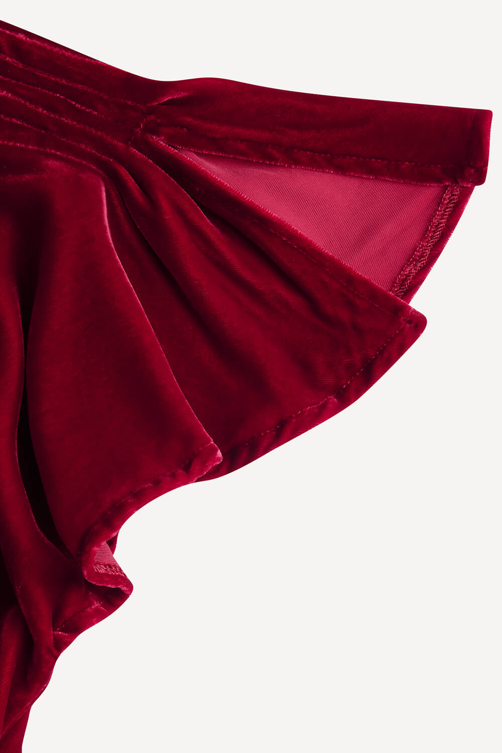 Close-up of a red velvet garment on a white background