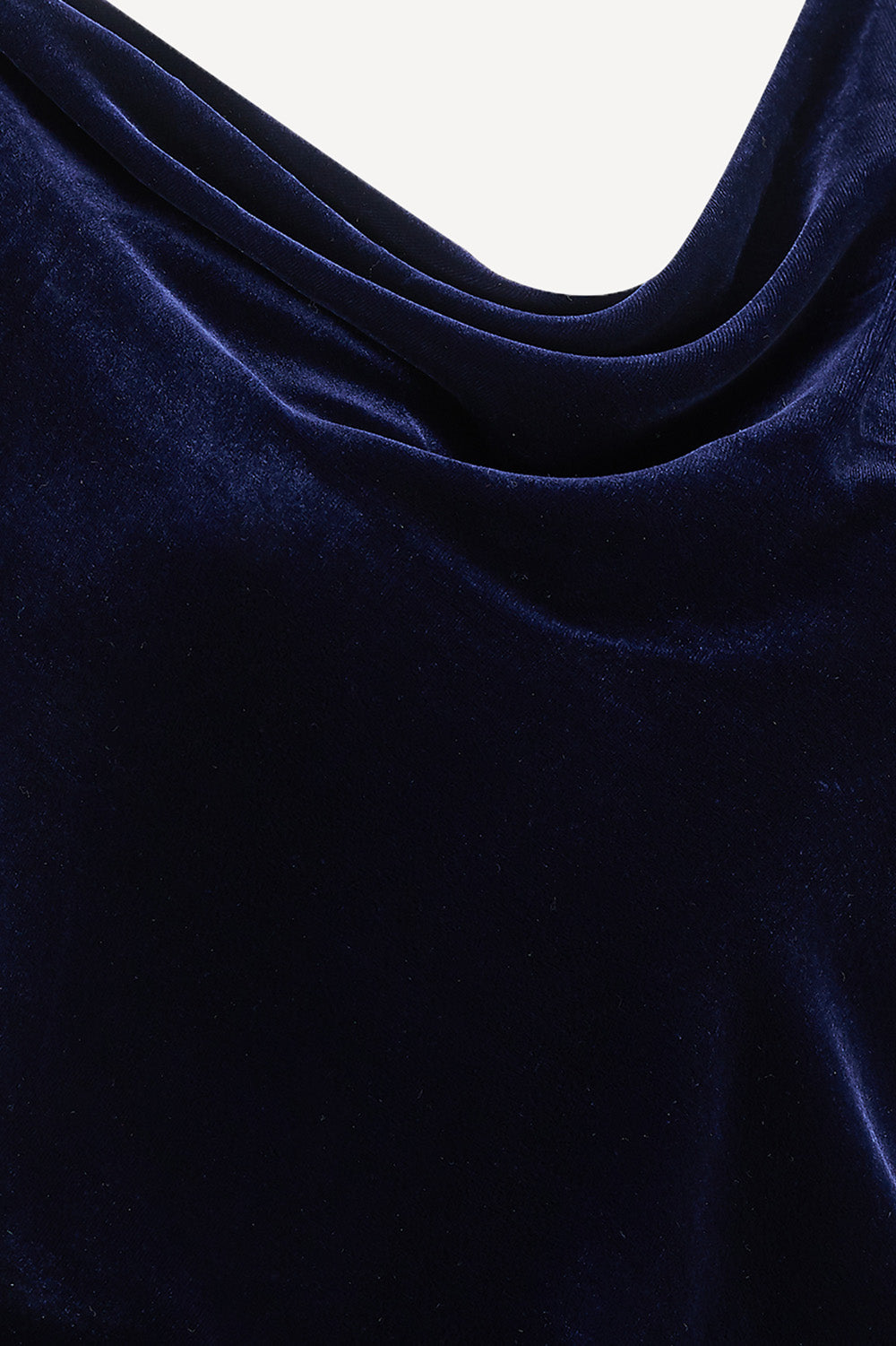 Close-up of dark blue fabric with folds on a white background
